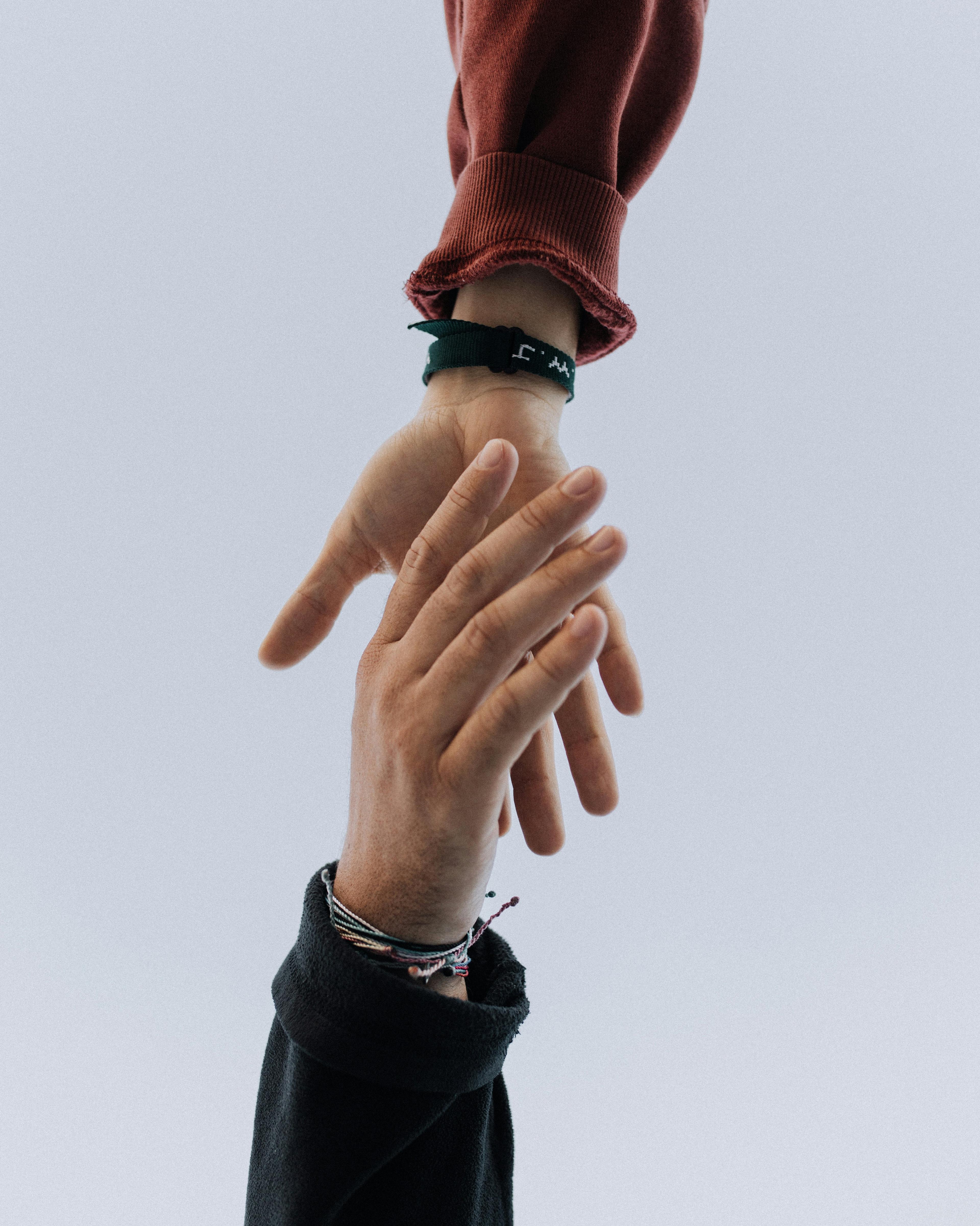 Two people holding hands